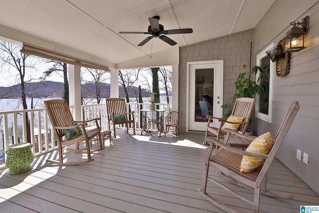 snow covered deck featuring a ceiling fan and a mountain view