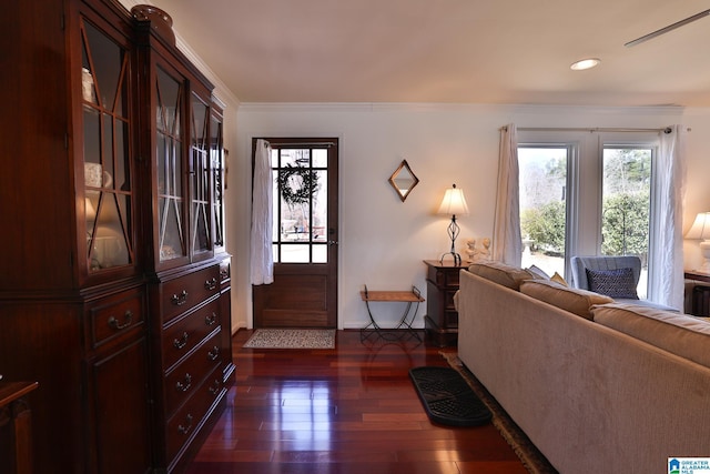 foyer entrance with dark wood-style floors, recessed lighting, and crown molding