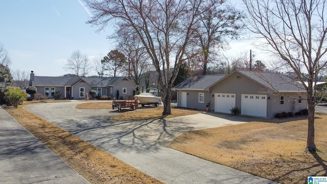 single story home featuring a garage and concrete driveway