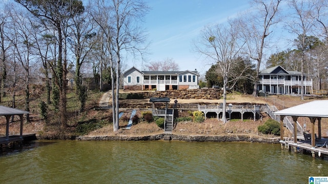 back of house with a gazebo, stairway, and a water view