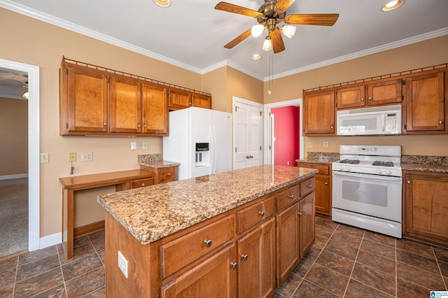 kitchen featuring brown cabinets, white appliances, and crown molding