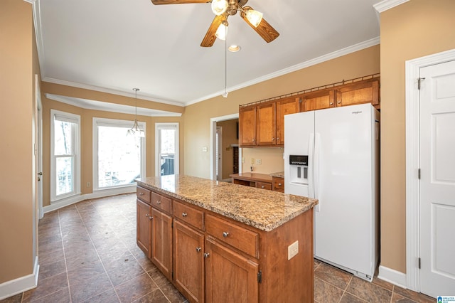 kitchen featuring brown cabinets, a center island, ornamental molding, and white fridge with ice dispenser