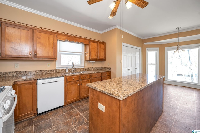 kitchen with ornamental molding, range, white dishwasher, brown cabinetry, and a sink