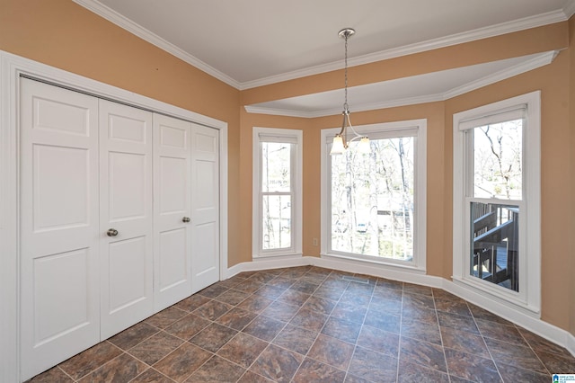 unfurnished dining area featuring plenty of natural light, baseboards, crown molding, and visible vents