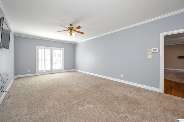 spare room featuring ceiling fan, carpet, baseboards, and ornamental molding