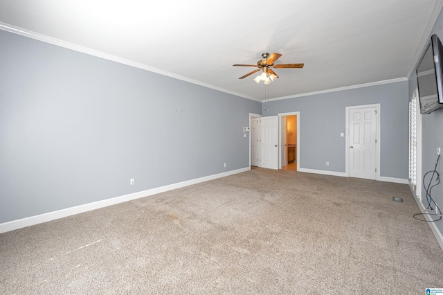 unfurnished bedroom featuring carpet flooring, baseboards, ensuite bathroom, and ornamental molding