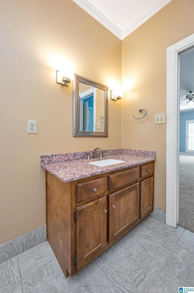 bathroom with vanity, crown molding, and ceiling fan