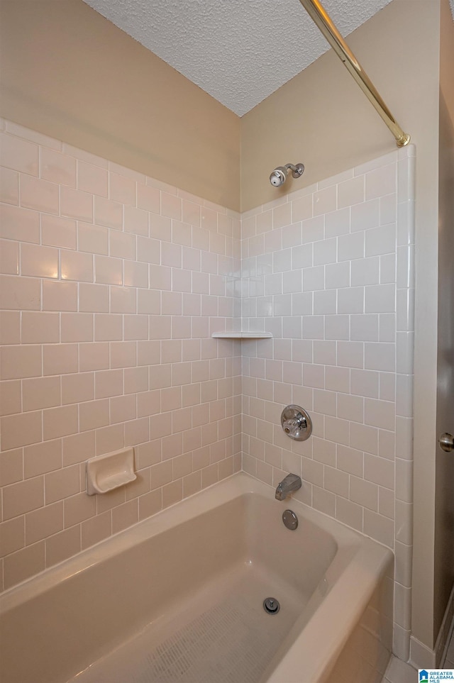 bathroom featuring shower / bath combination and a textured ceiling