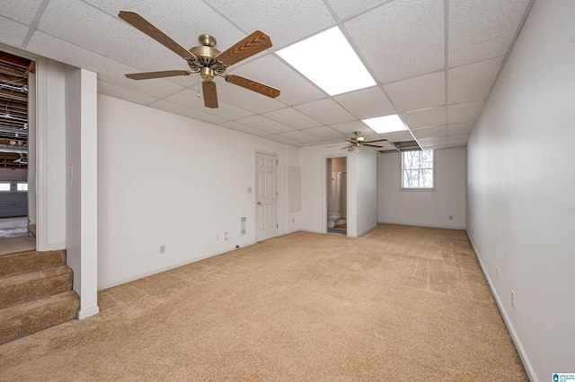 interior space with stairs, light colored carpet, and a paneled ceiling