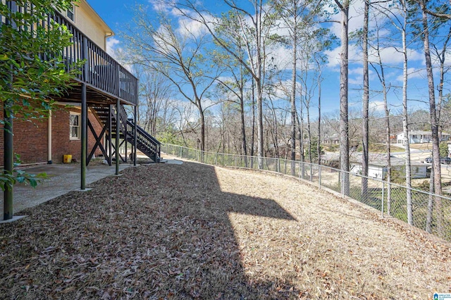 view of yard featuring stairway, a wooden deck, and fence