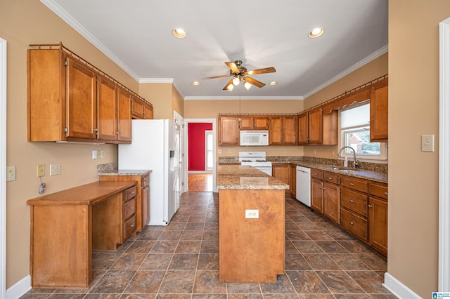 kitchen featuring brown cabinets, ornamental molding, a sink, a center island, and white appliances