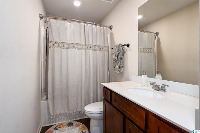 bathroom with visible vents, toilet, vanity, and shower / bath combo