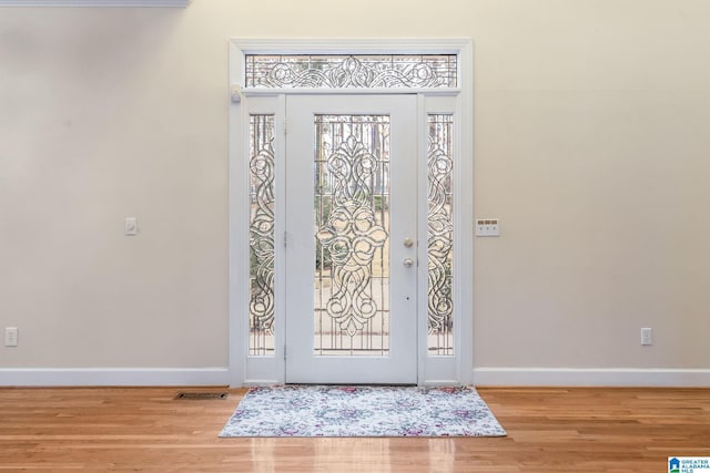 entrance foyer featuring visible vents, baseboards, and wood finished floors