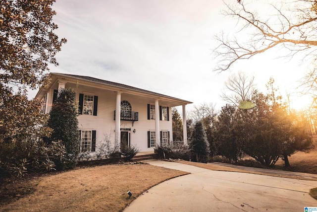 greek revival inspired property featuring a balcony