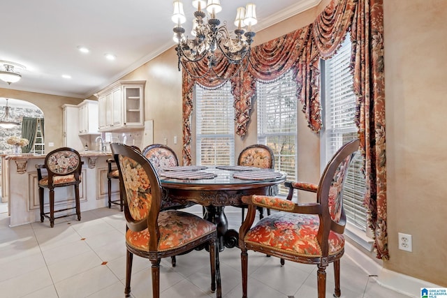 dining area with plenty of natural light, a notable chandelier, and ornamental molding