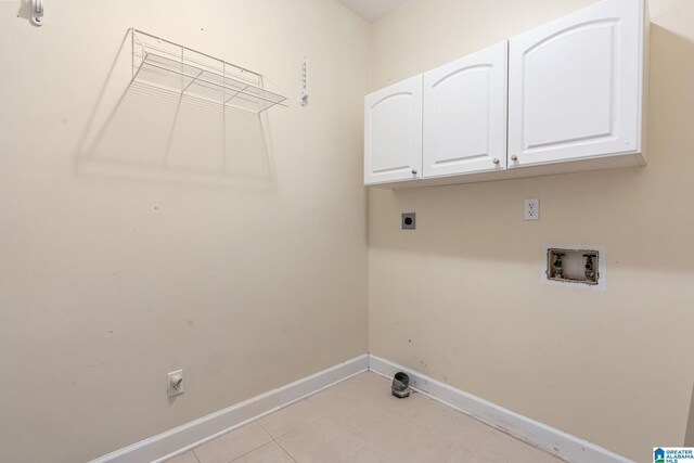 laundry area featuring baseboards, cabinet space, hookup for an electric dryer, and washer hookup