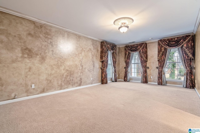 empty room featuring carpet flooring, baseboards, and ornamental molding