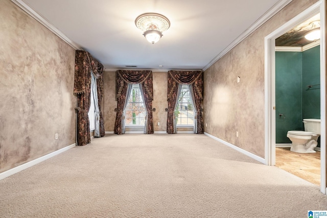 carpeted empty room featuring visible vents, baseboards, and ornamental molding