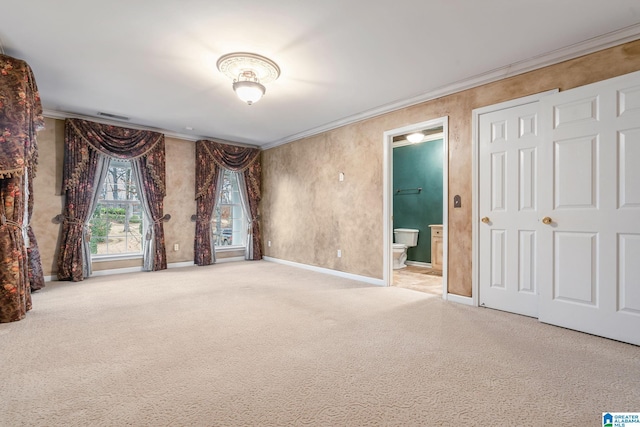 unfurnished room featuring visible vents, baseboards, carpet flooring, and crown molding