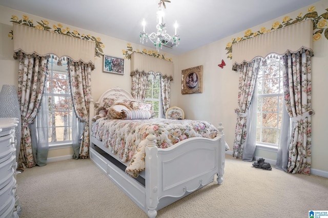 bedroom with a notable chandelier, carpet flooring, and baseboards