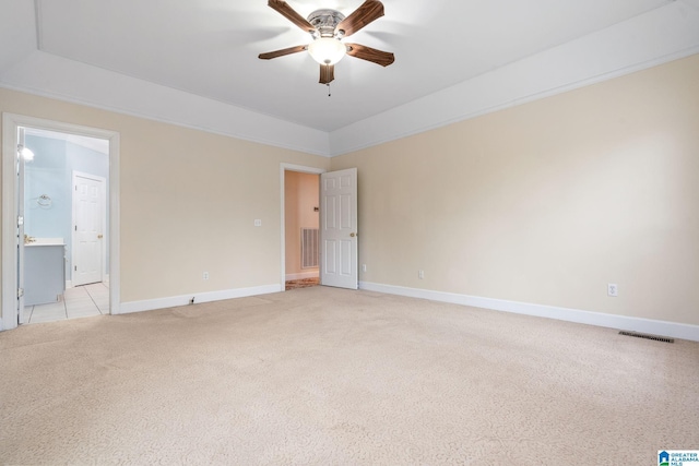 unfurnished room with baseboards, light colored carpet, visible vents, and ceiling fan