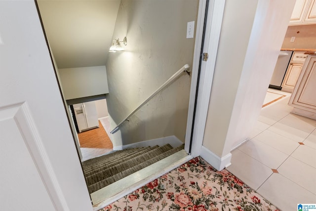 staircase with tile patterned flooring and baseboards