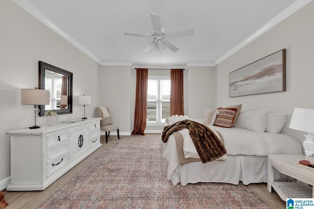 bedroom featuring light wood-style floors, a ceiling fan, crown molding, and baseboards