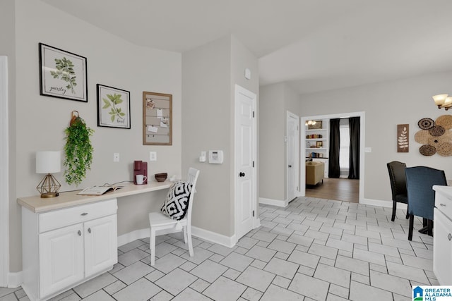 home office with built in desk and baseboards