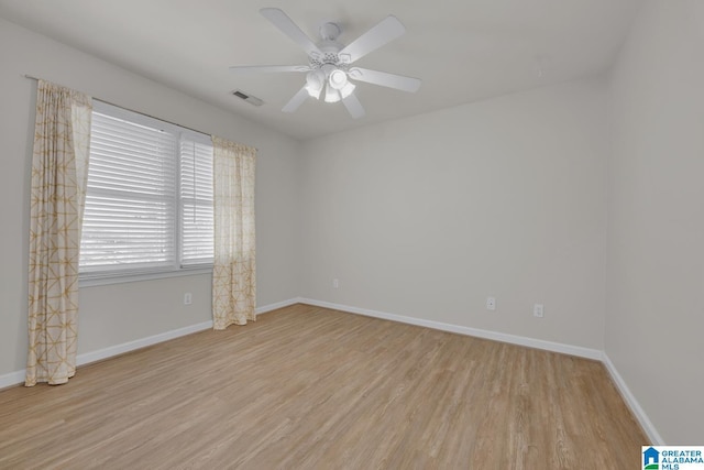 empty room featuring visible vents, baseboards, light wood-style floors, and a ceiling fan