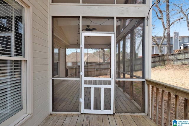 wooden deck with fence and a sunroom