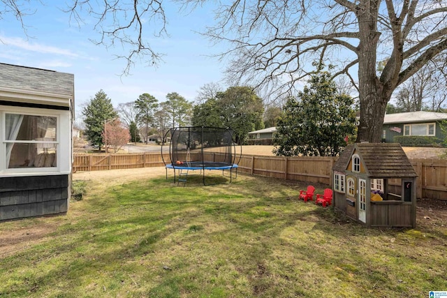 view of yard with a fenced backyard and a trampoline