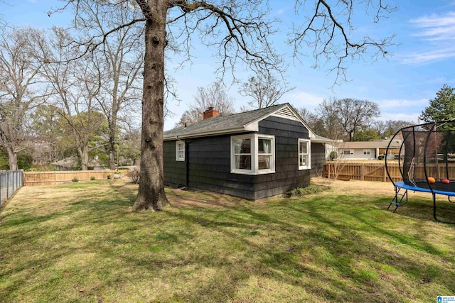 view of yard featuring a fenced backyard and a trampoline