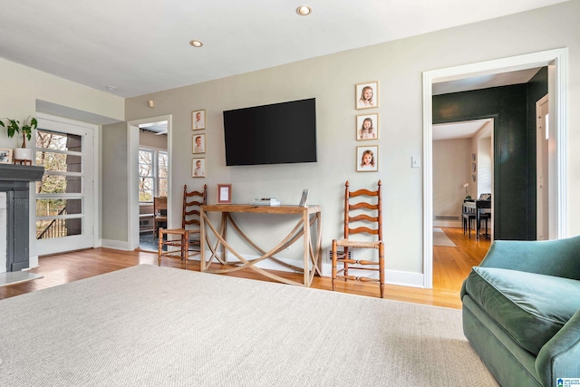 living area with recessed lighting, wood finished floors, and baseboards