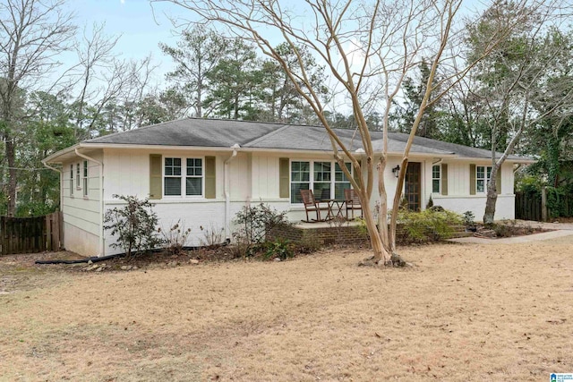 ranch-style house with fence