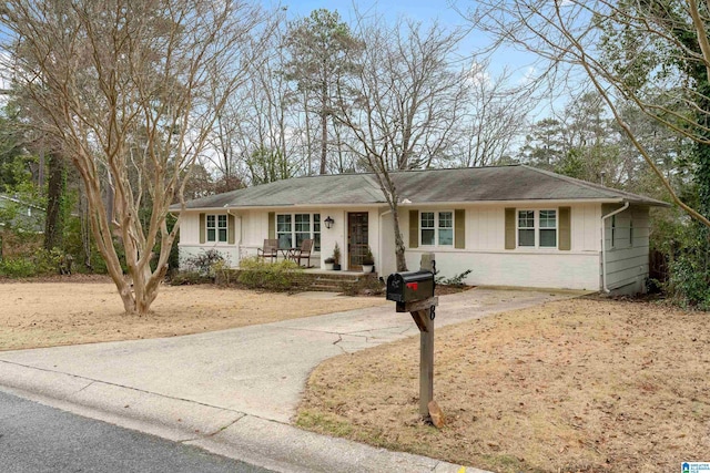 single story home featuring covered porch and driveway