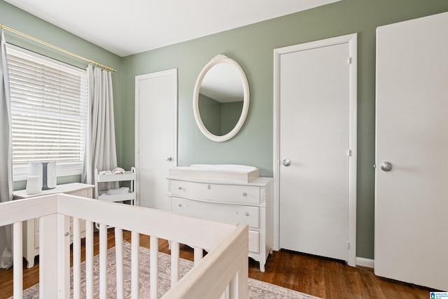 bedroom with dark wood-type flooring