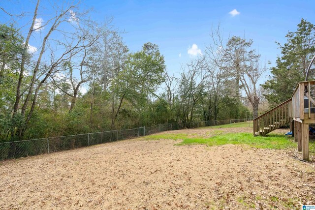 view of yard featuring stairway and fence