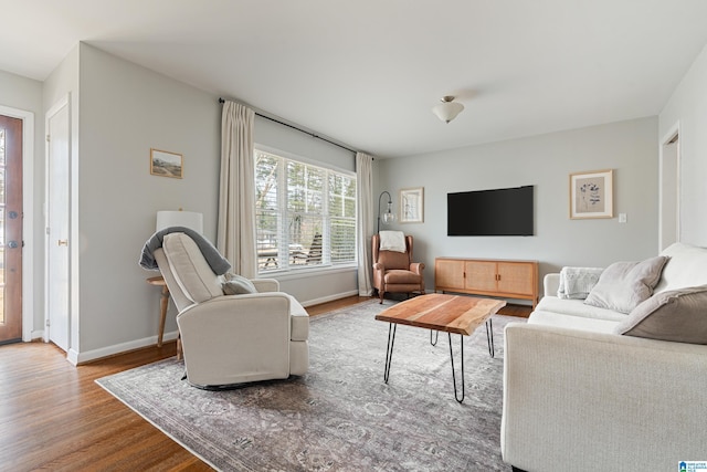 living room with baseboards and wood finished floors