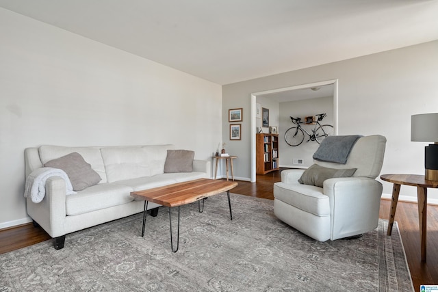 living room featuring baseboards and wood finished floors