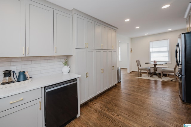 kitchen featuring dark wood-style floors, recessed lighting, freestanding refrigerator, decorative backsplash, and light countertops