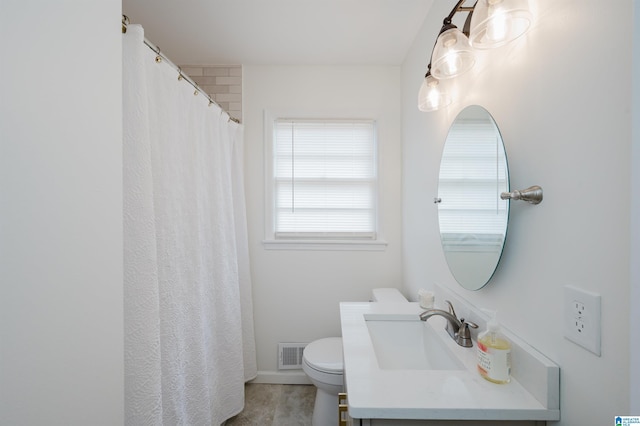 bathroom featuring visible vents, toilet, vanity, and baseboards