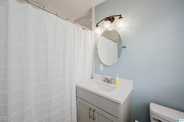 full bathroom with toilet and vanity