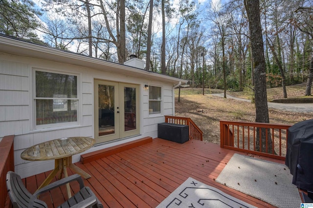 wooden deck with a grill and french doors