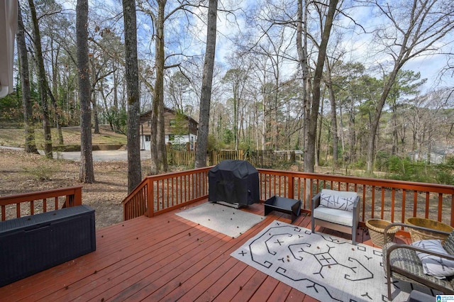 wooden terrace with area for grilling, outdoor dining area, and fence