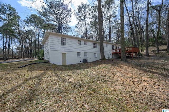 rear view of house featuring a wooden deck and central AC unit