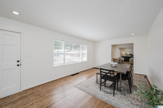 dining space with recessed lighting, wood finished floors, visible vents, and baseboards