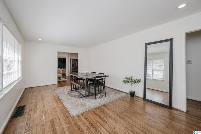 dining area with recessed lighting, visible vents, light wood-style flooring, and baseboards