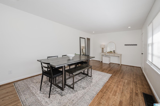 dining room with visible vents, recessed lighting, baseboards, and wood finished floors