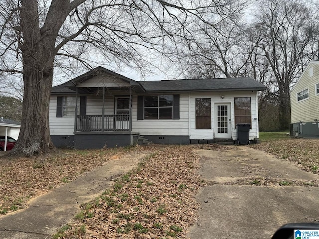 view of front of home with crawl space, covered porch, and roof with shingles