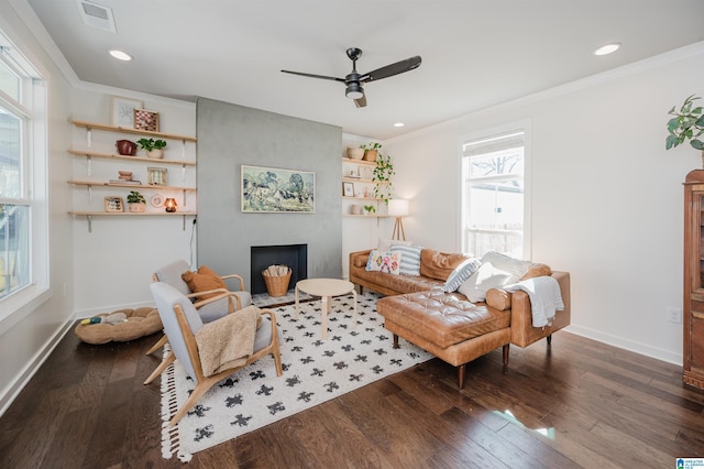 living area with visible vents, baseboards, wood finished floors, and a ceiling fan